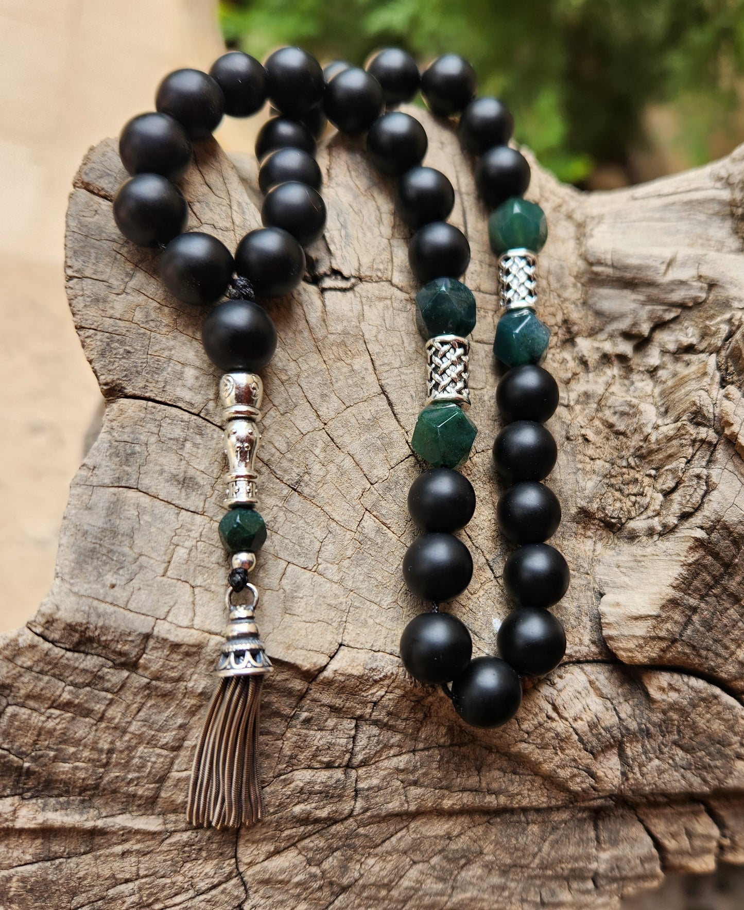 Black and green beaded misbaha on a wooden surface