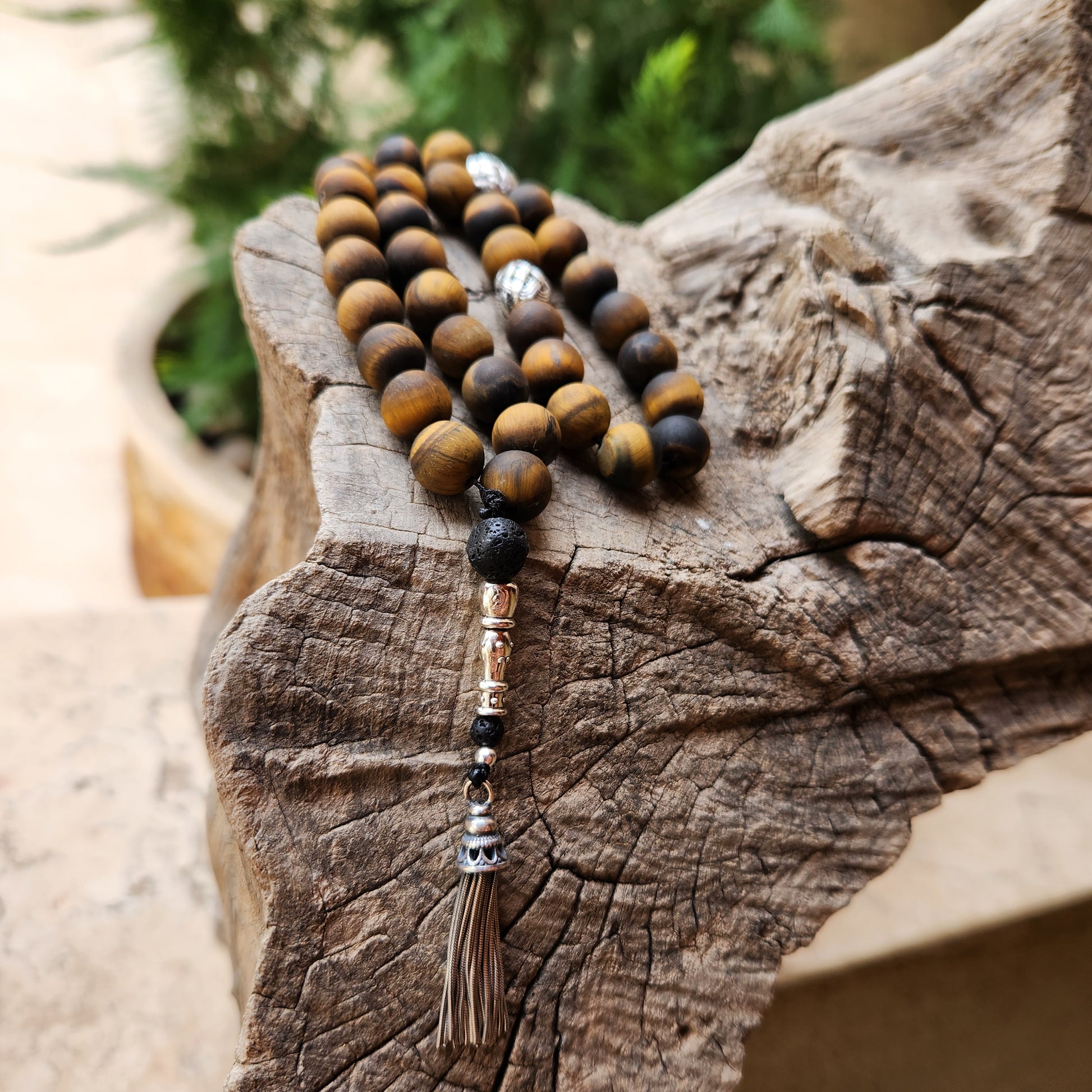 Wooden like beaded misbaha with tassel on a wooden surface