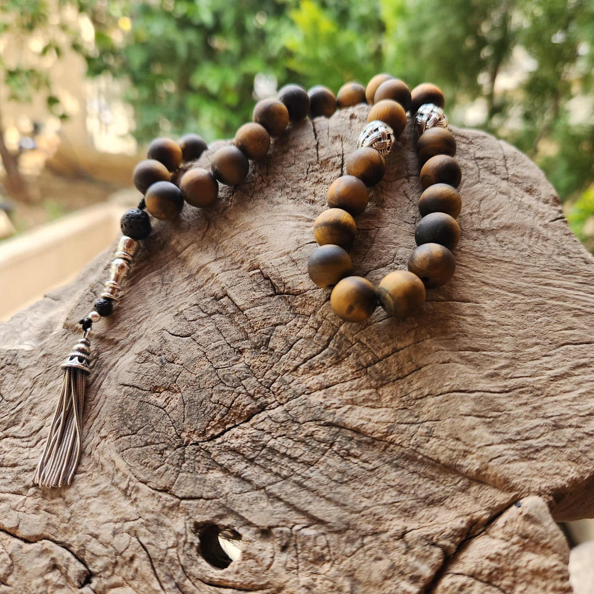 Wooden like beaded misbaha with tassel on a wooden surface