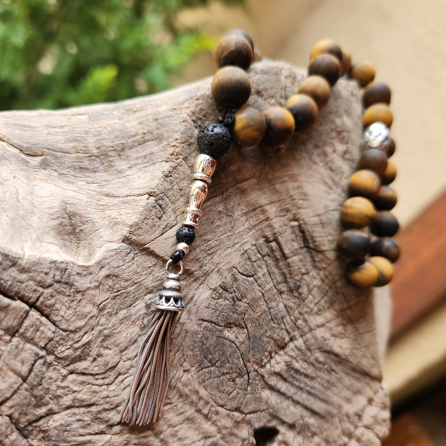 Wooden like beaded misbaha with tassel on a wooden surface