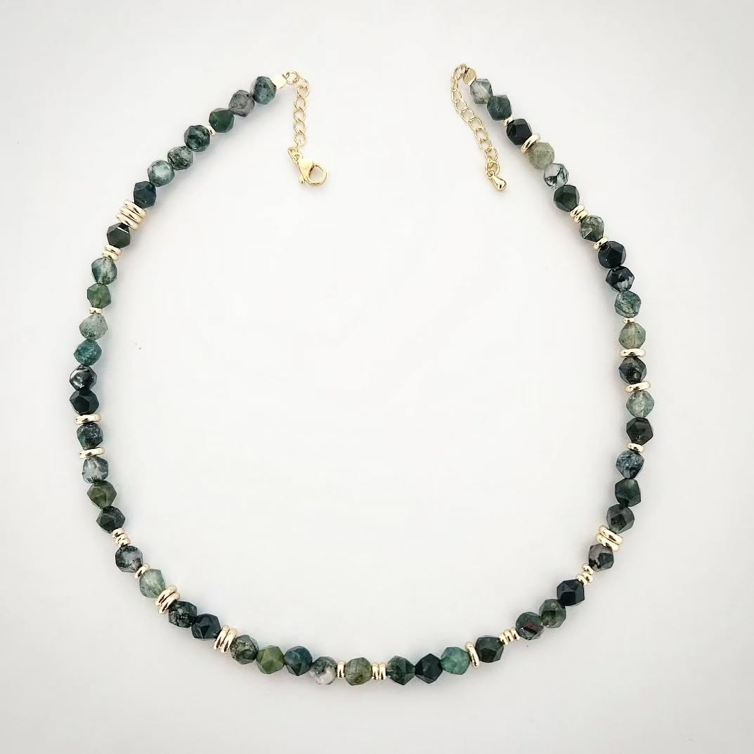 Necklace with green Moss Agate stone and gold accents on a white background