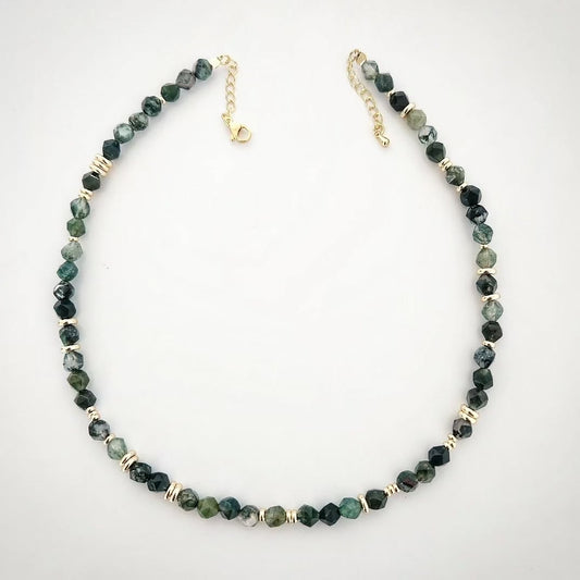 Necklace with green Moss Agate stone and gold accents on a white background