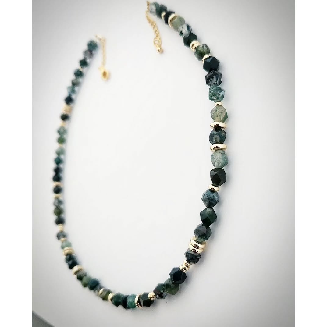 Necklace with green Moss Agate stone and gold accents on a white background