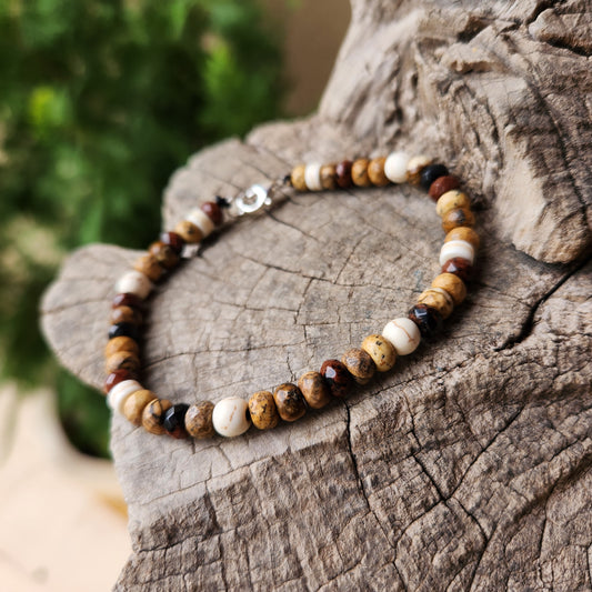 Beaded bracelet on a wooden surface with a blurred green background
