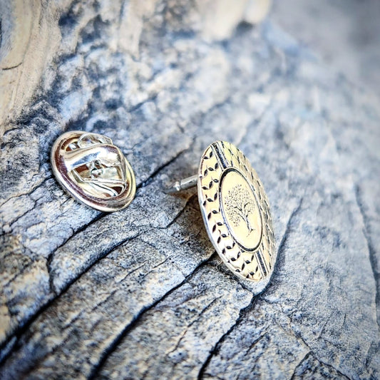 Silver pin on a textured wooden surface