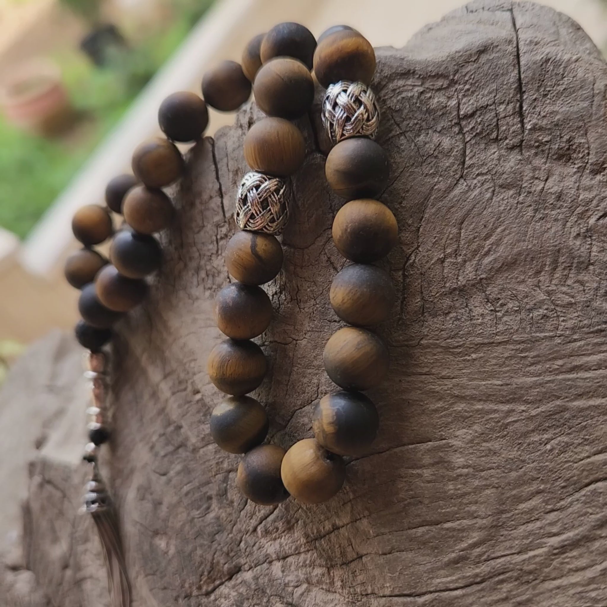 Wooden like beaded misbaha with tassel on a wooden surface